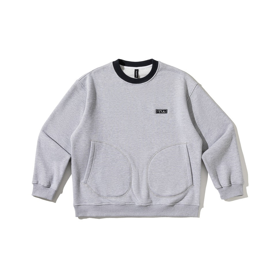 Light gray crewneck sweatshirt with black collar trim, a small chest badge, and two rounded front pockets.
