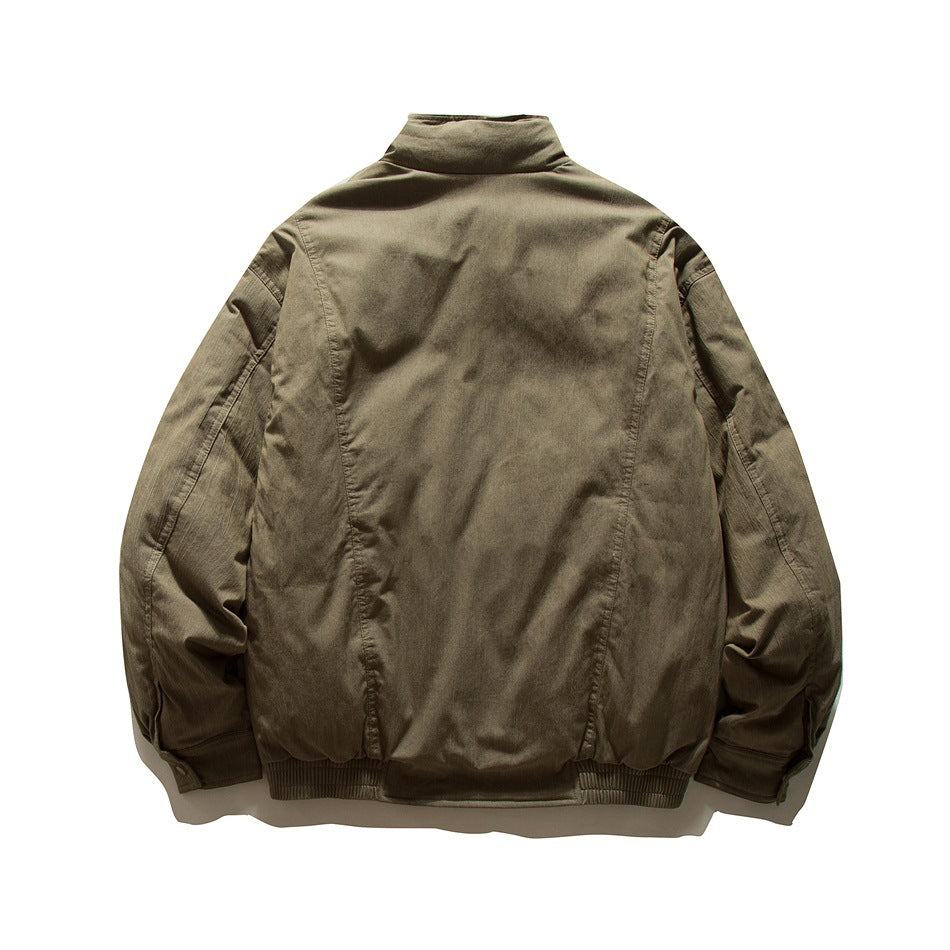Back view of gray-green padded jacket with stand collar, panel seams, ribbed hem and cuff button tabs