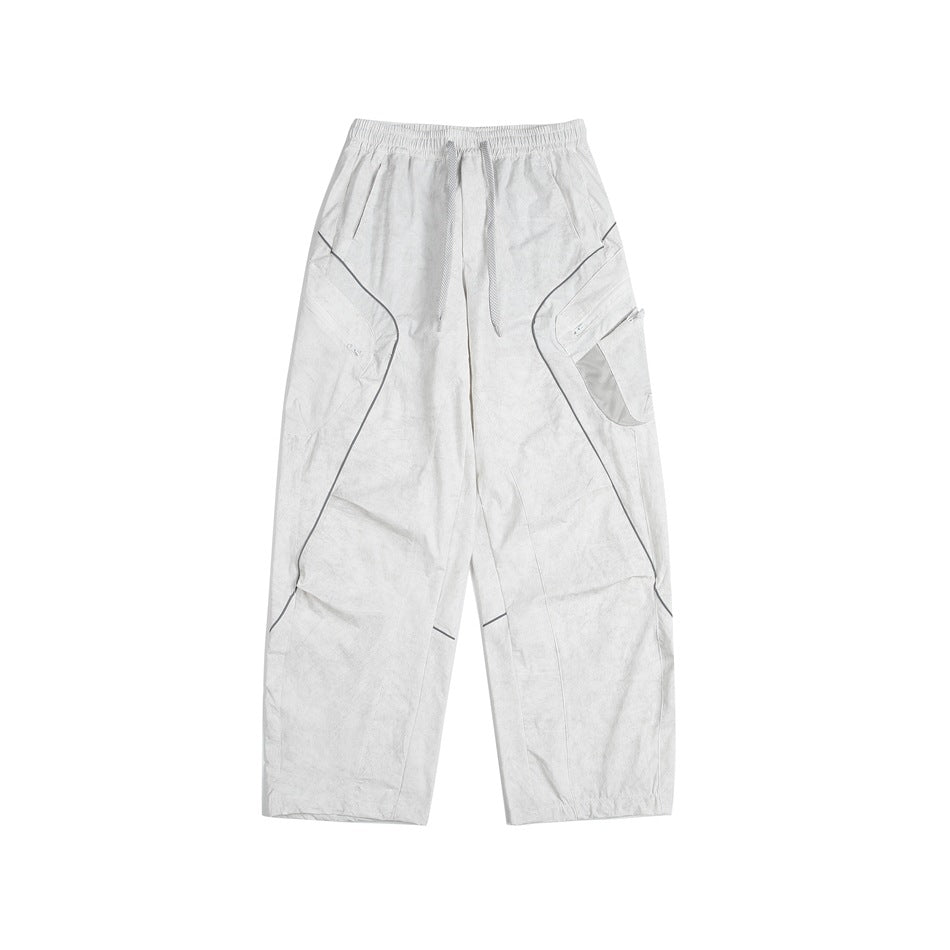 White wide-leg cargo pants with drawstring waist, curved piping and zippered mesh side pocket, flat lay
