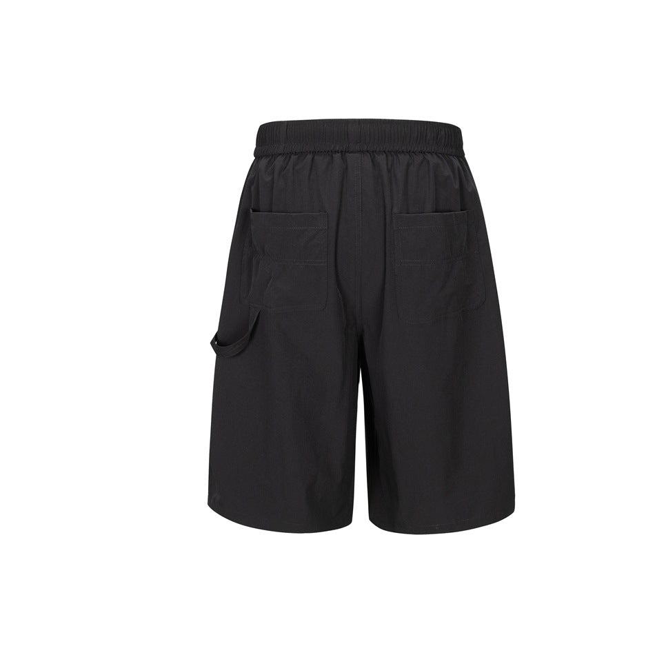 Black shorts back view with two patch pockets, elastic waistband and side loop strap