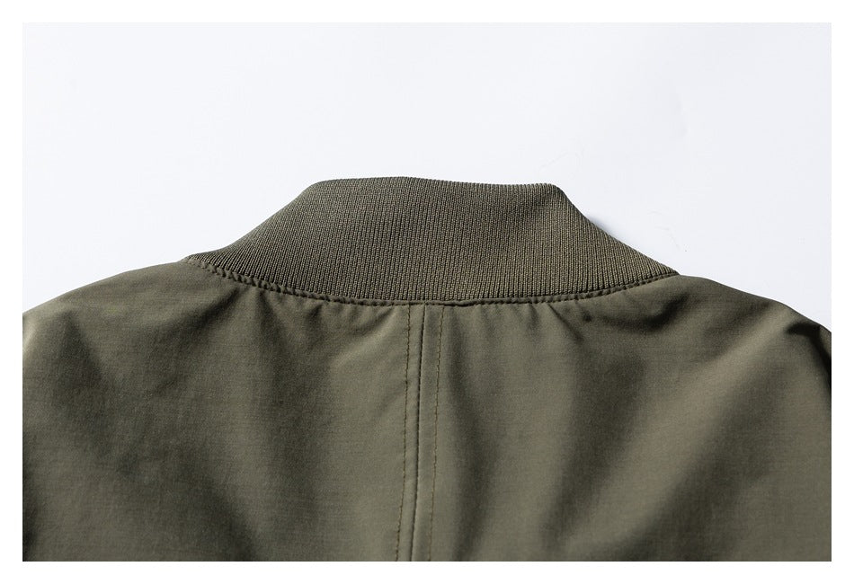 Cropped rear view of an olive green jacket showing its ribbed stand collar and center back seam.