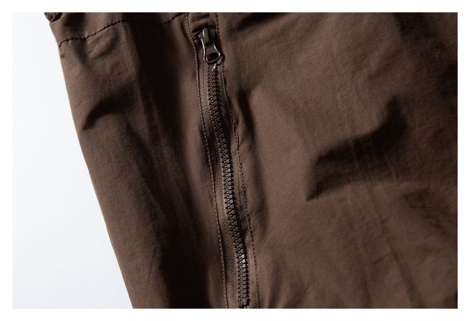 Close-up of a dark brown jacket with a vertical front zipper.