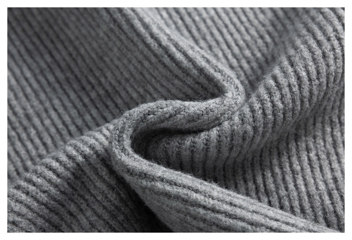 Close-up of gray ribbed knit fabric arranged in soft folds.