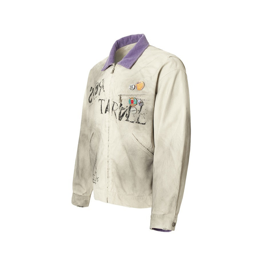 Front three-quarter view of a cream jacket with a purple collar, chest pins, zip closure, and distressed black graphics.