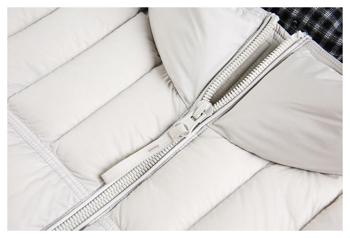 Close-up of the off-white puffer jacket's chunky front zipper and quilted panels.