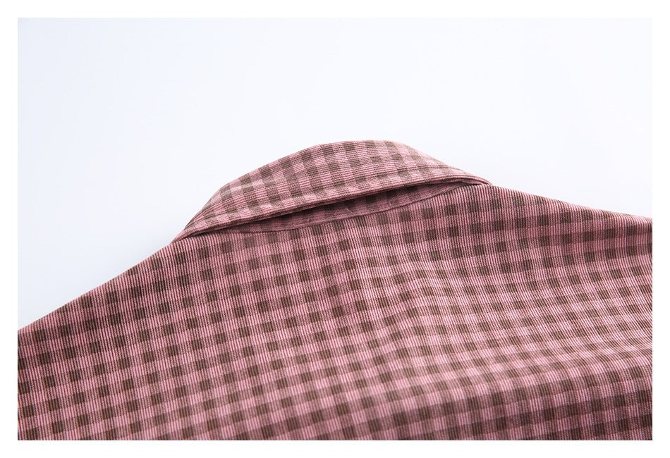 Close-up of a pink and brown checked garment collar and fabric.