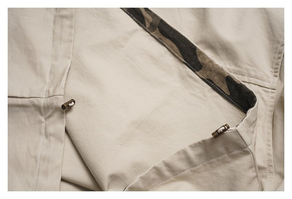 Close-up of the jacket's interior construction, camouflage-print facing, and adjustable drawcord toggles.