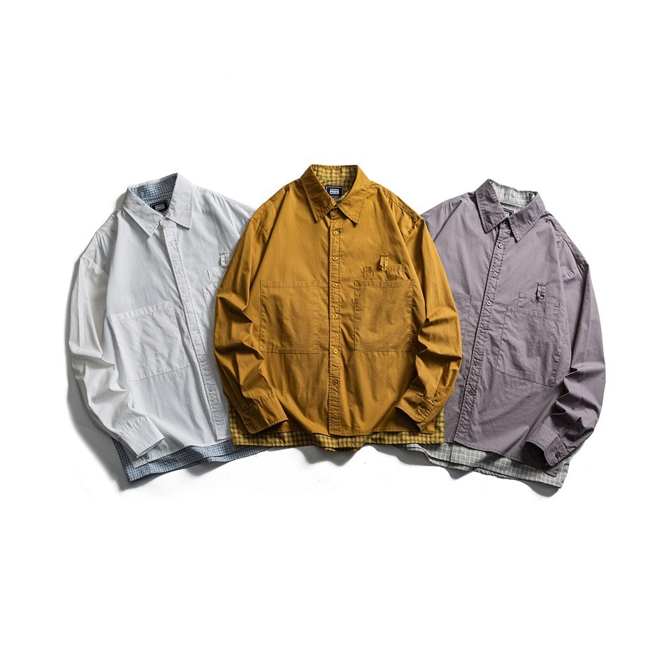 Three button-up shirts laid flat: white, mustard, and mauve, each with a chest pocket and plaid lining.