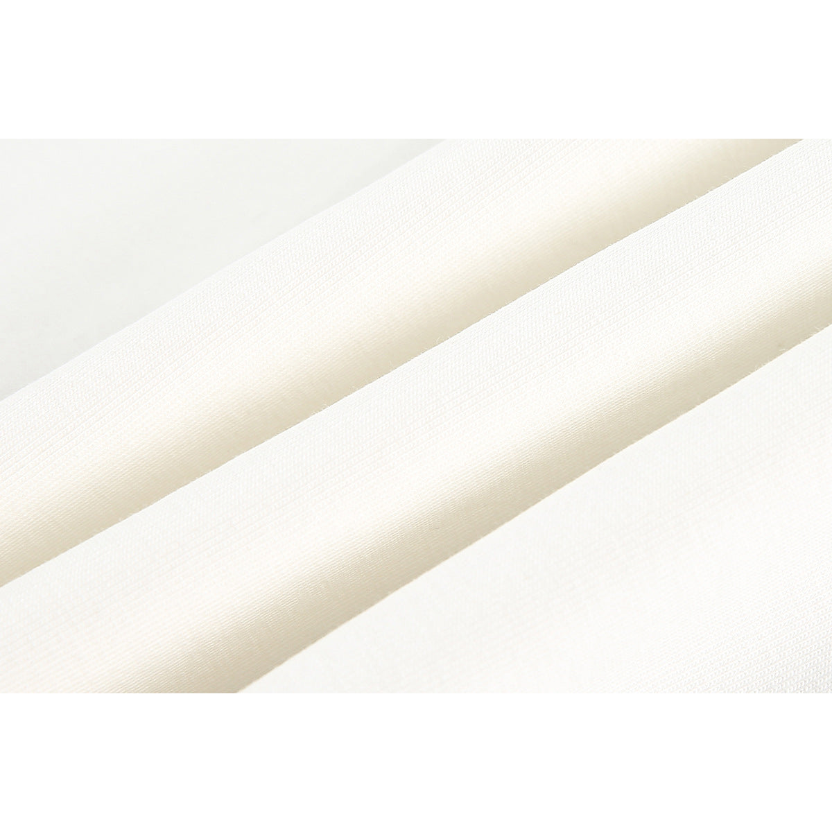 Close-up showing the fine surface texture and folds of light-colored fabric.