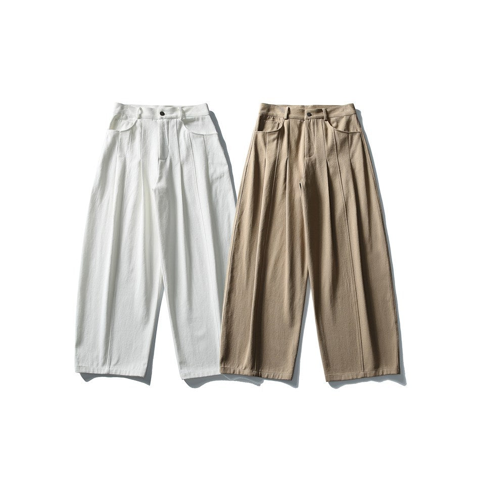 Two pairs of wide-leg pleated trousers shown from the front in white and beige.