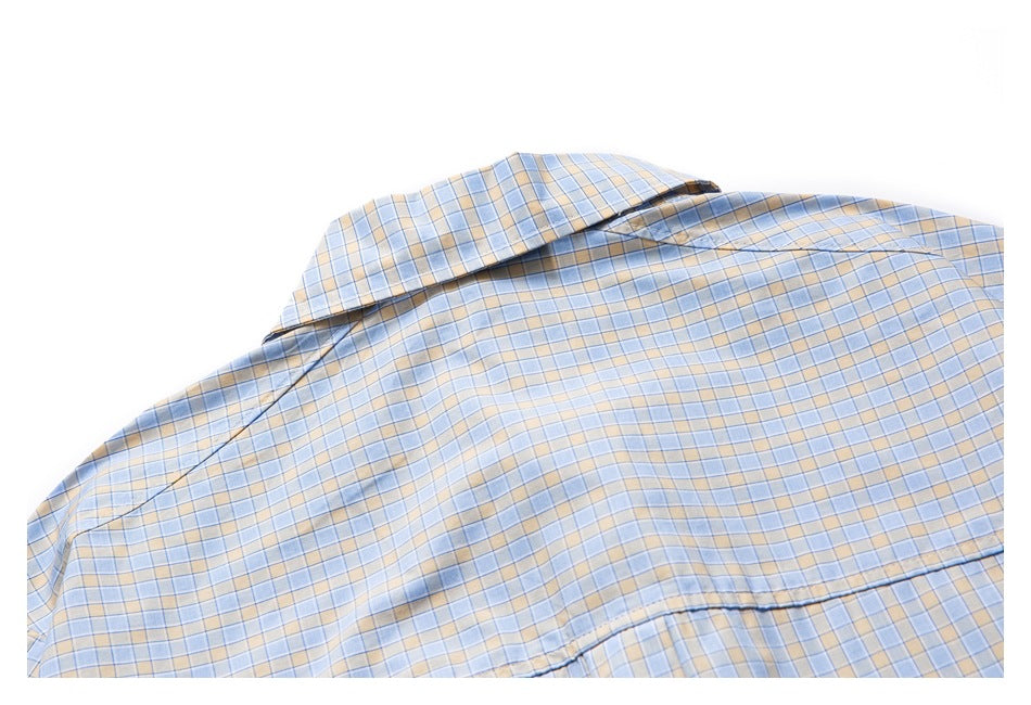 Close-up of the plaid shirt's back, showing its collar and yoke seam.