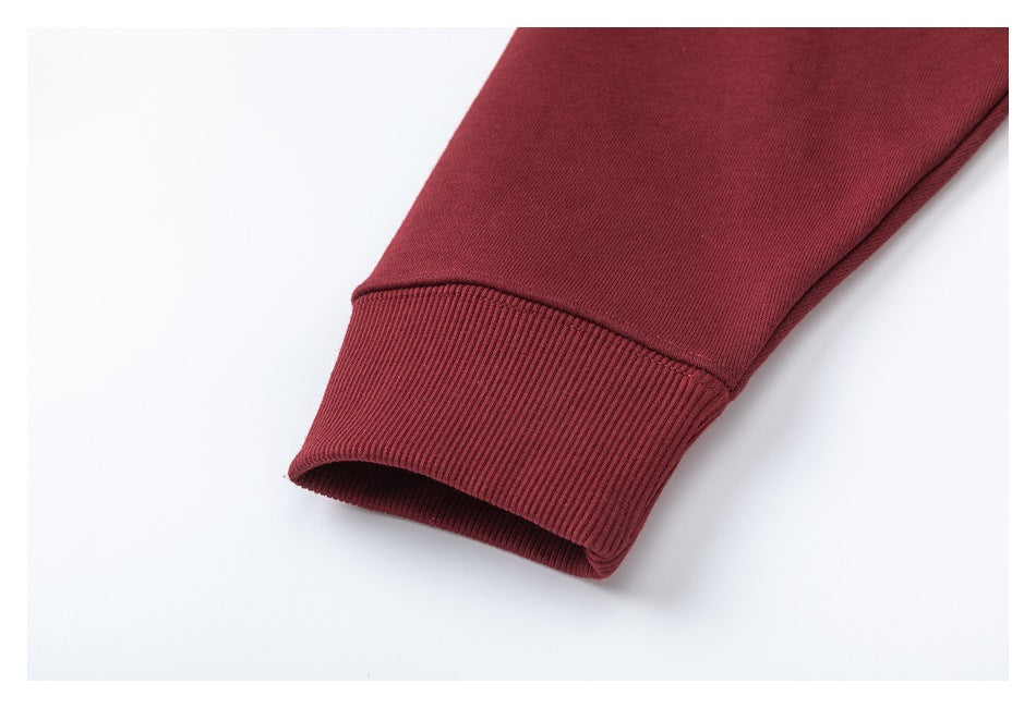Close-up of a burgundy sleeve ending in a wide ribbed cuff.
