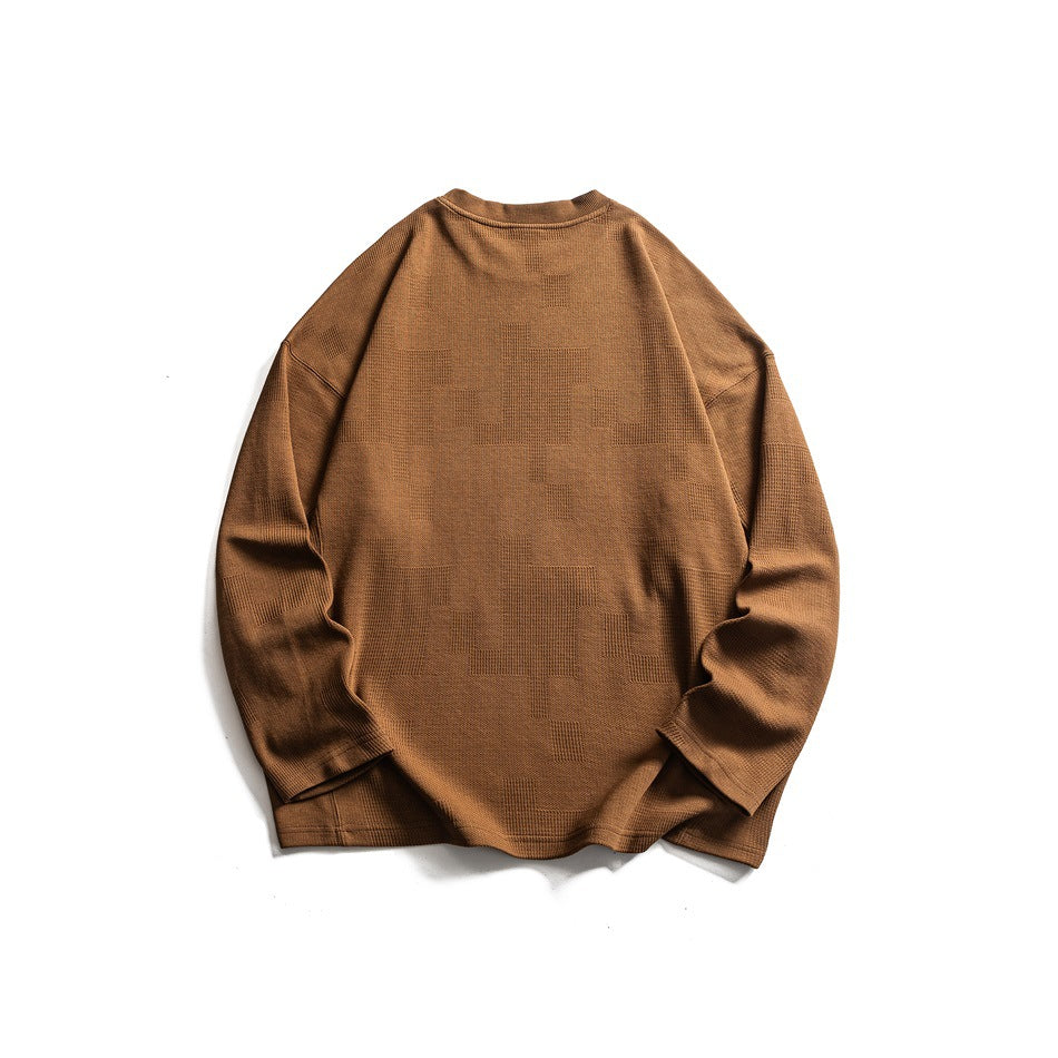 Back view of a camel-brown long-sleeve crewneck top laid flat.