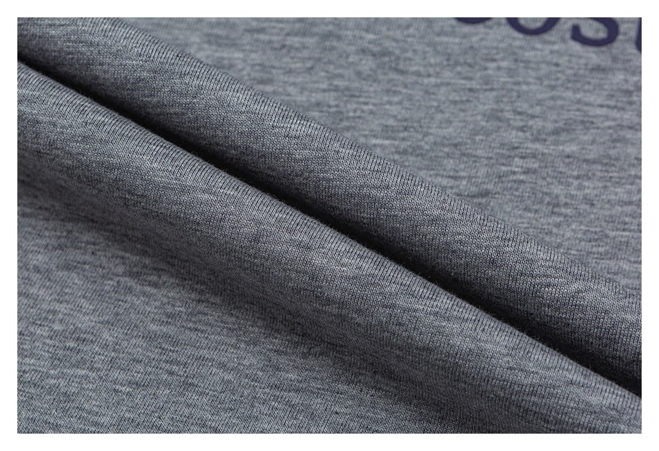 Close-up of heather-gray shirt fabric draped to show its knit texture.