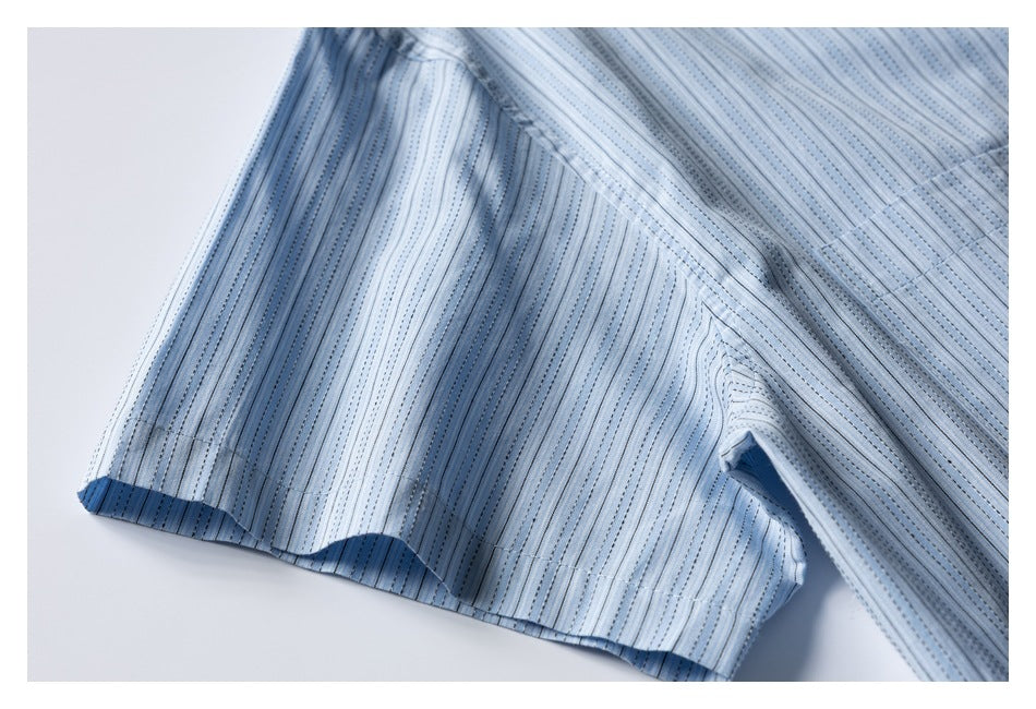 Close-up of a light blue striped shirt sleeve and hem.