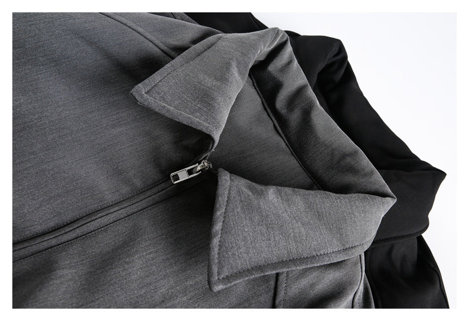 Close-up of a gray jacket lapel and zipper, with part of a black jacket visible behind it.