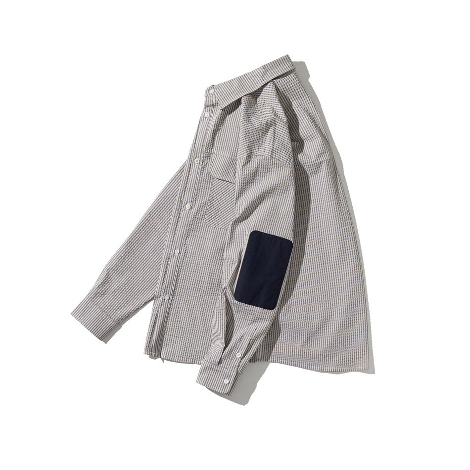 Taupe-and-white striped long-sleeve button-up shirt arranged flat, with a chest pocket and navy sleeve patch.