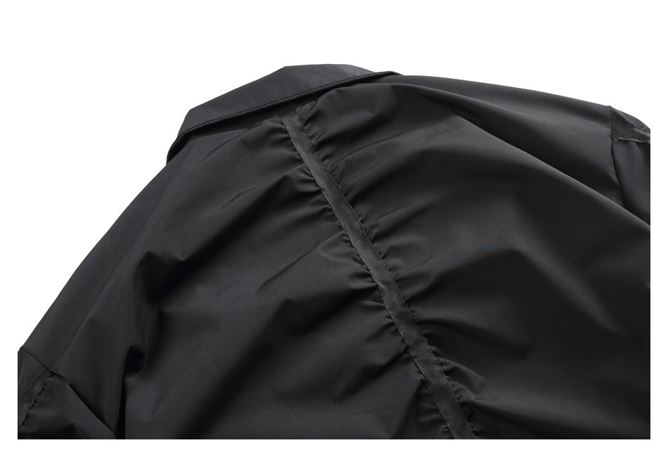 Close-up of a black garment shoulder area with a reinforced seam.