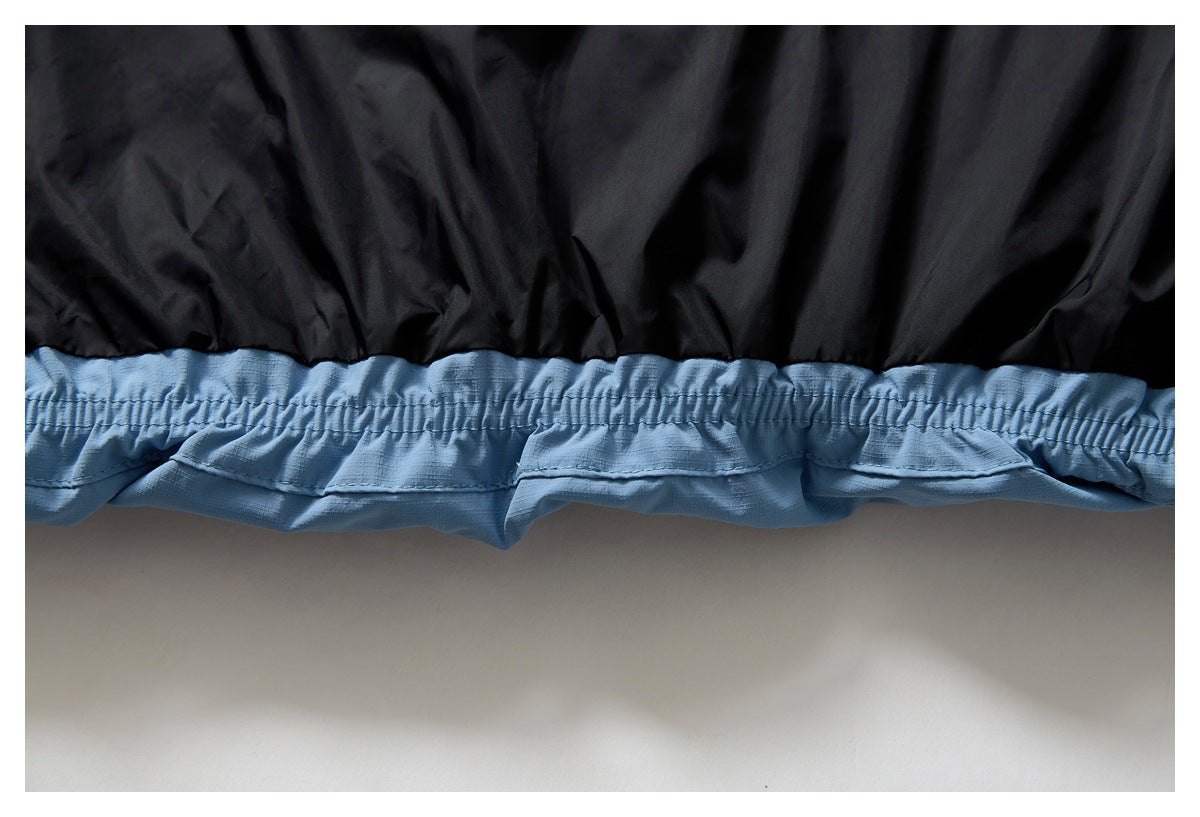 Close-up of the light blue jacket hem, with gathered elastic trim beneath the black lining.