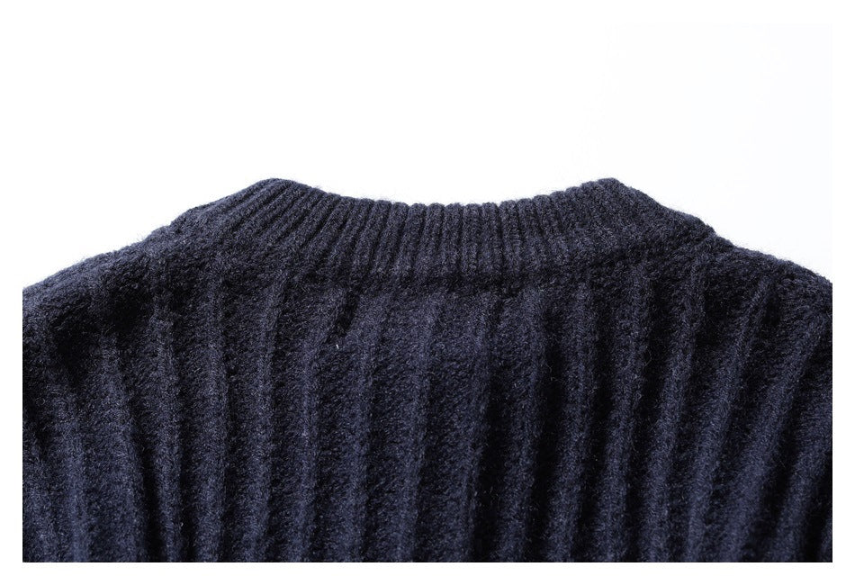 Close-up of a dark navy rib-knit sweater neckline and upper shoulder.