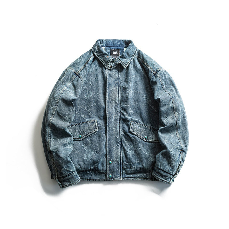 Blue washed denim jacket with floral pattern, zipped closed, flat lay showing collar, flap pockets and snap placket