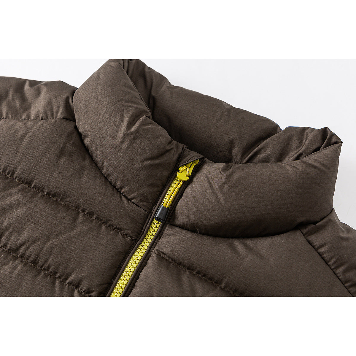 Close-up of a dark brown quilted jacket collar and bright yellow front zipper.