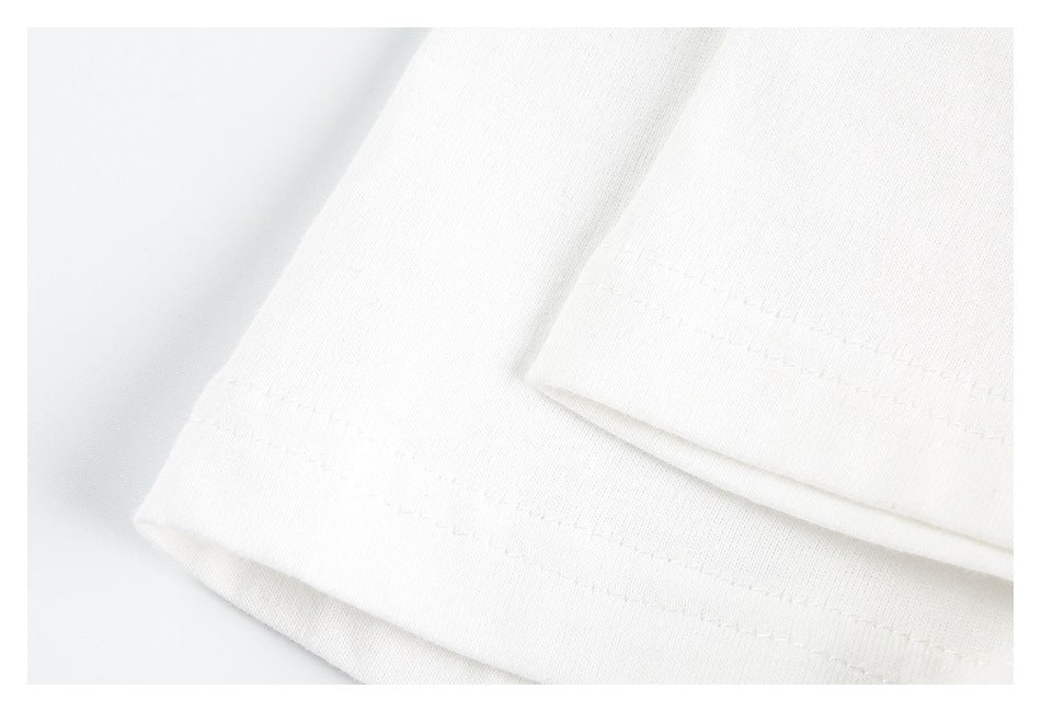 Close-up of the white T-shirt's sleeve hem and double-row stitching.