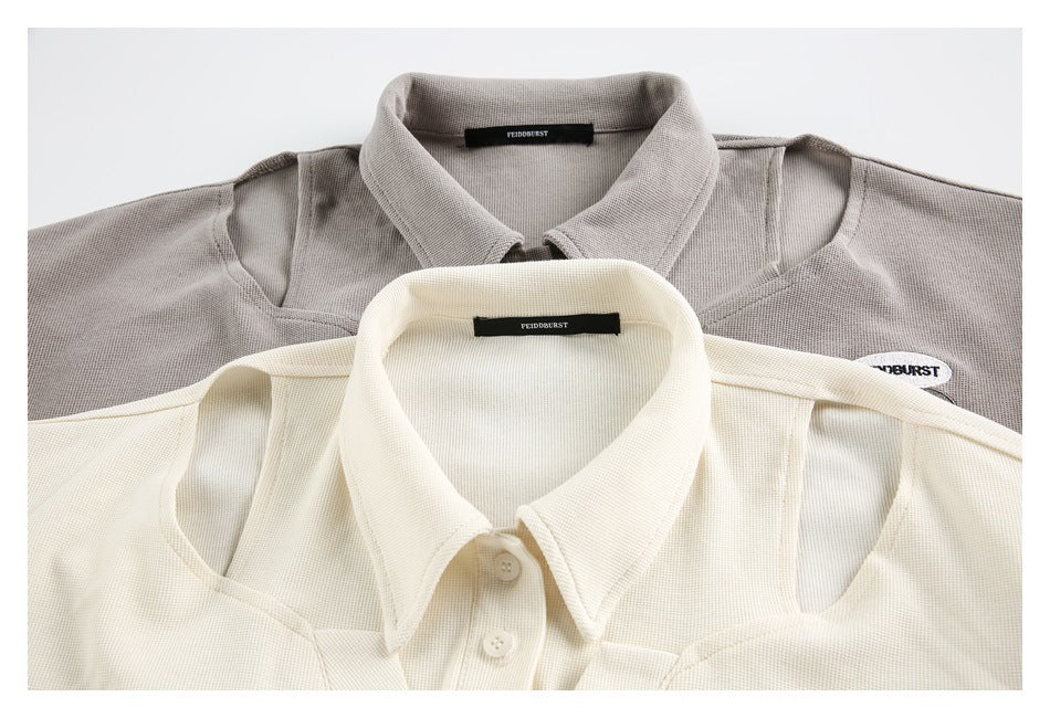 Close-up of the collars and shoulder cutouts on light gray and ivory short-sleeve tops.