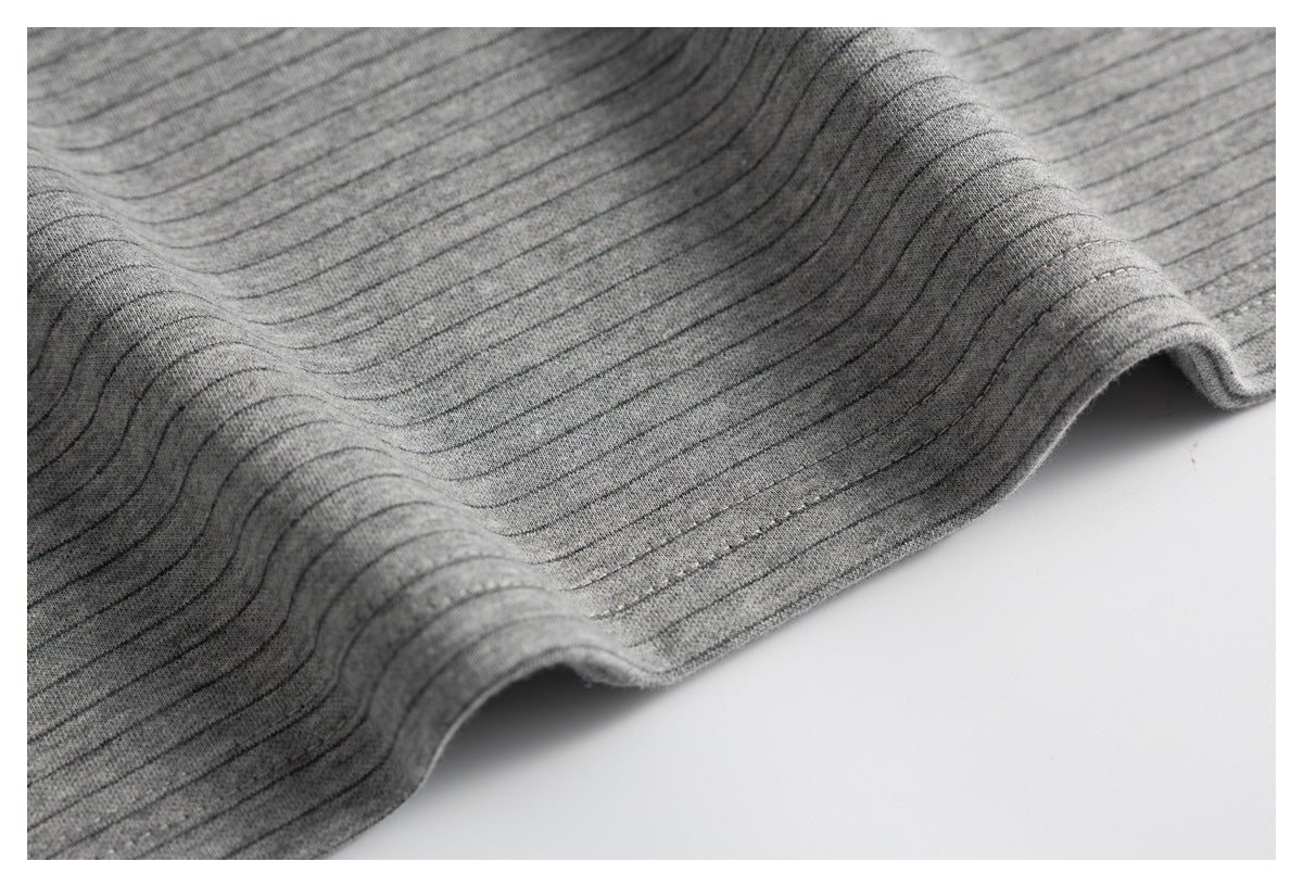 Close-up of the gray striped top’s fabric and stitched hem.