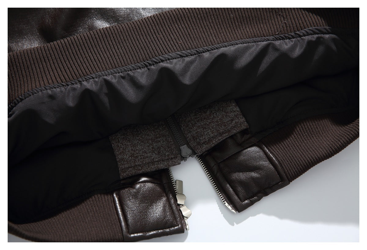Close-up of the jacket's dark brown ribbed hem, black lining and metal zipper hardware.