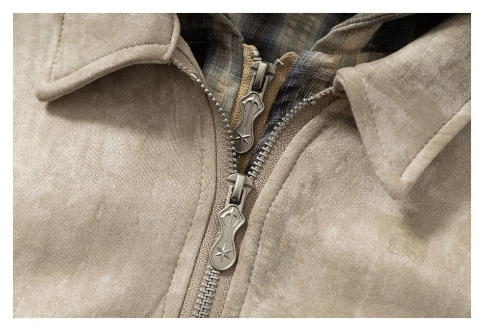 Close-up of the jacket's double zipper pulls, wide collar and plaid hood lining.