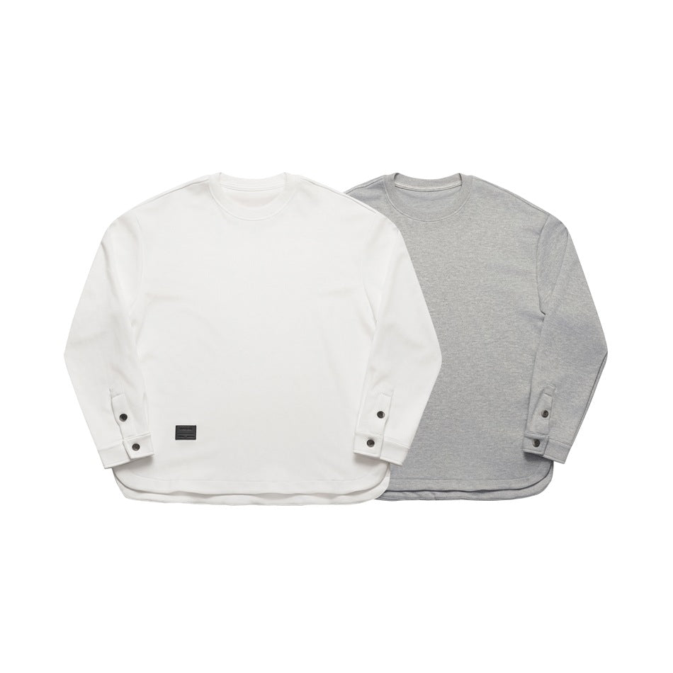 White and heather gray long-sleeve crewneck tops shown from the front, with buttoned sleeve tabs.