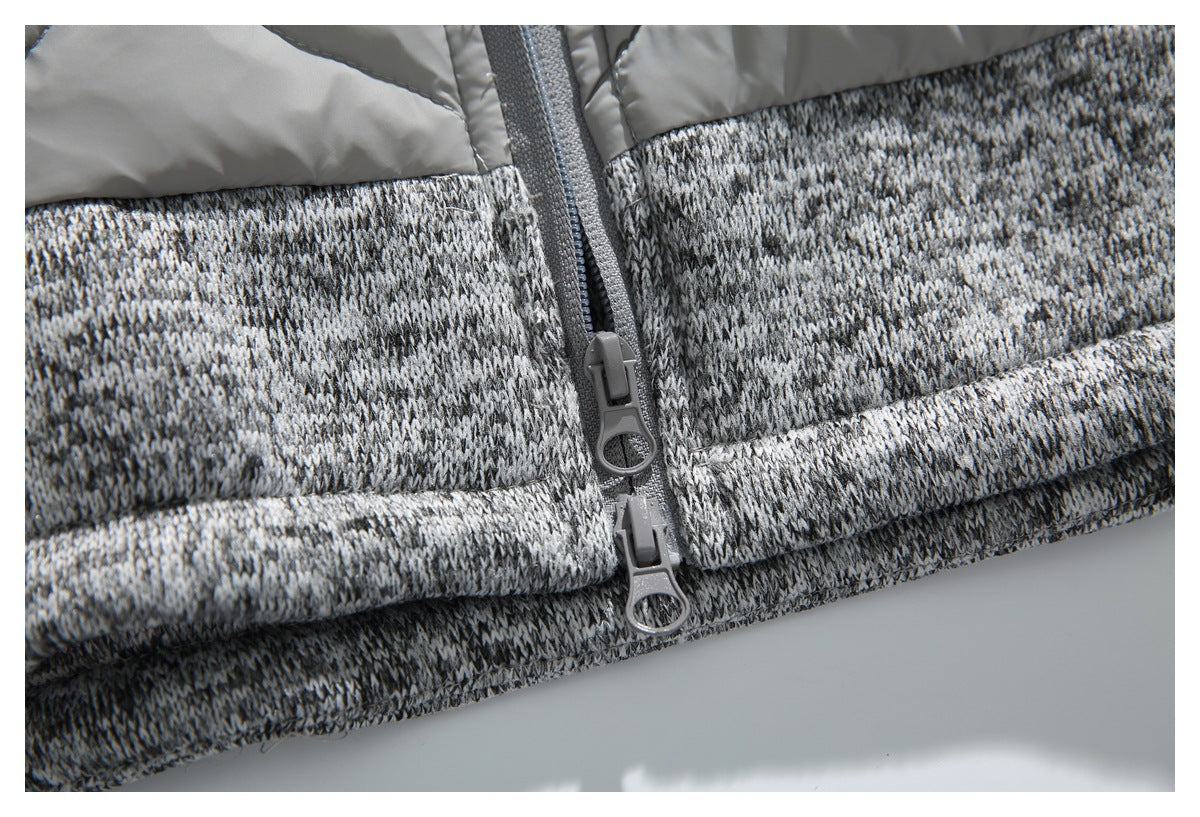Close-up of two zipper pulls at the join between the jacket's gray knit and padded sections.