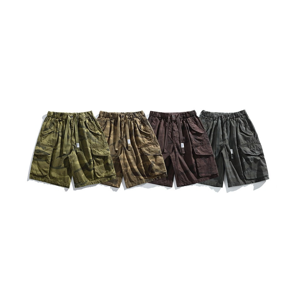 Four pairs of cargo shorts arranged side by side in olive, brown, burgundy, and charcoal camouflage colorways.
