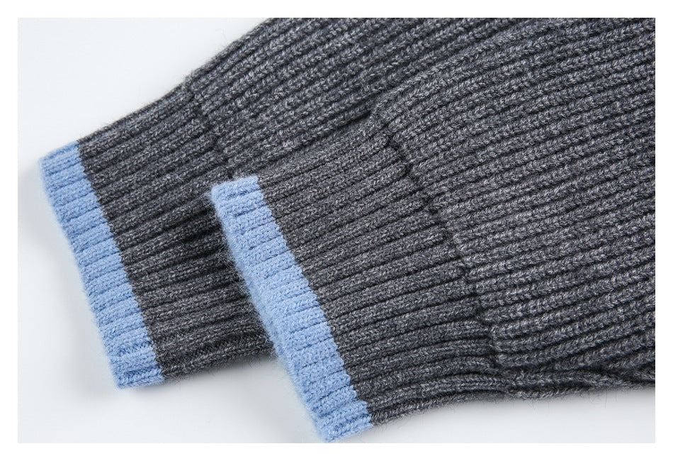 Close-up of charcoal rib-knit sleeves with light blue contrasting cuffs.