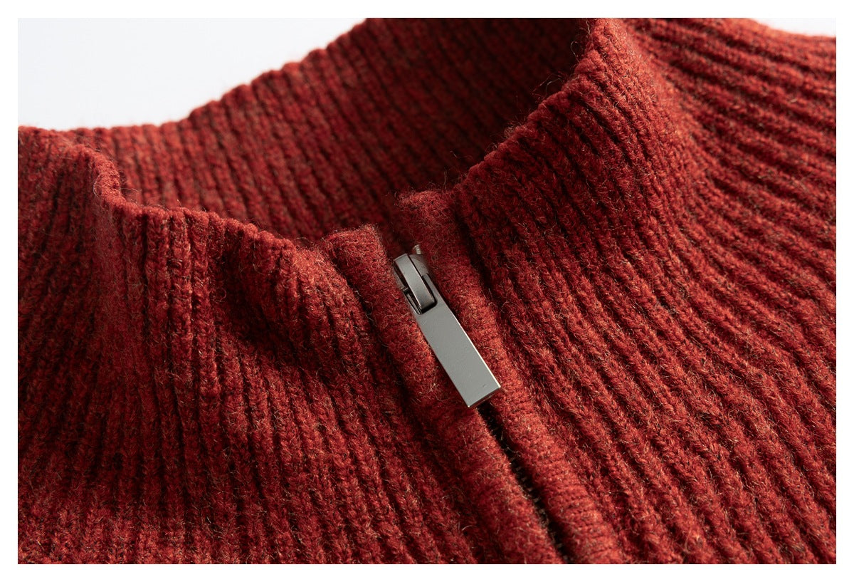 Close-up of the rust-red sweater's ribbed collar and metal zipper pull.