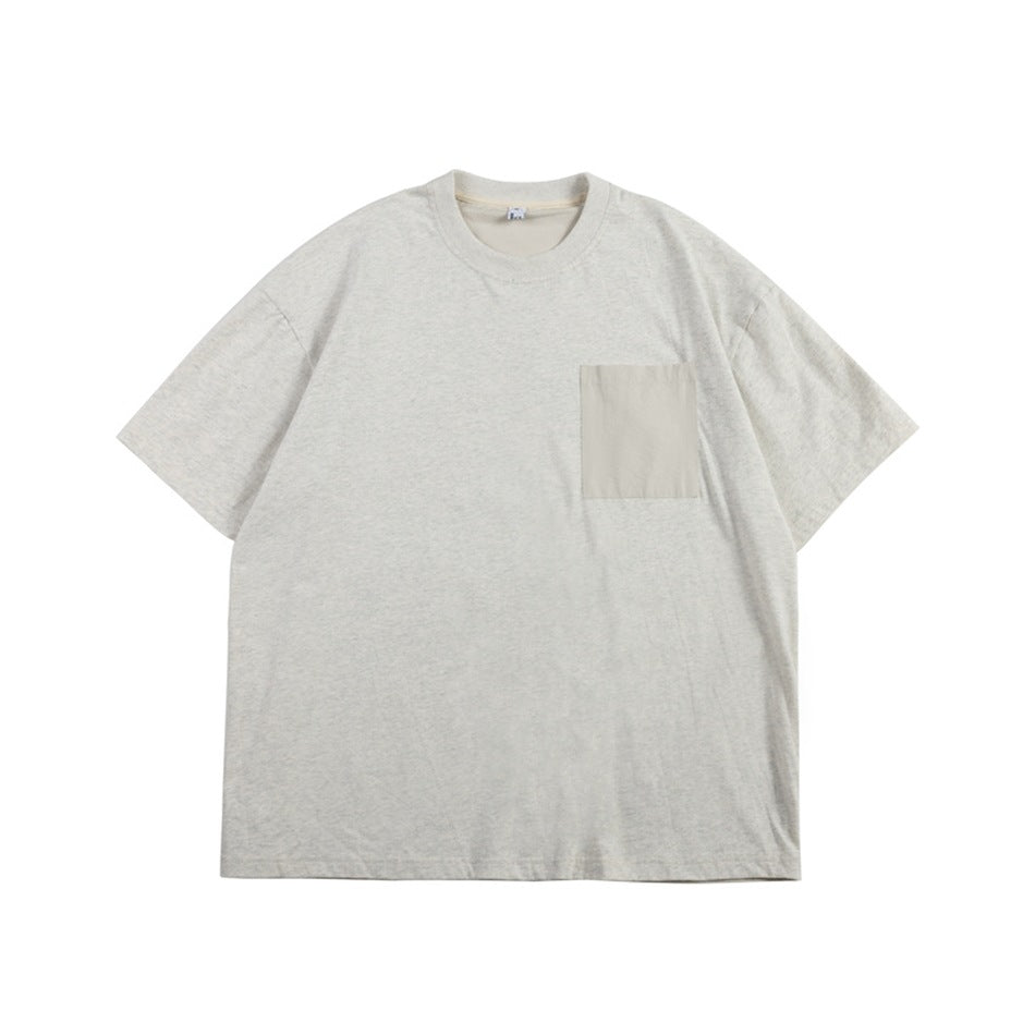 Heathered light gray short-sleeve T-shirt with a pale beige square chest pocket, flat lay