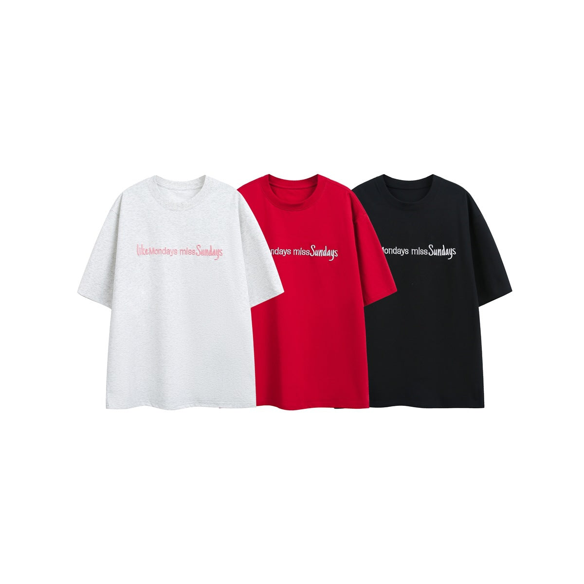 Front view of oversized crew-neck T-shirts in light gray, red, and black, each with chest lettering.