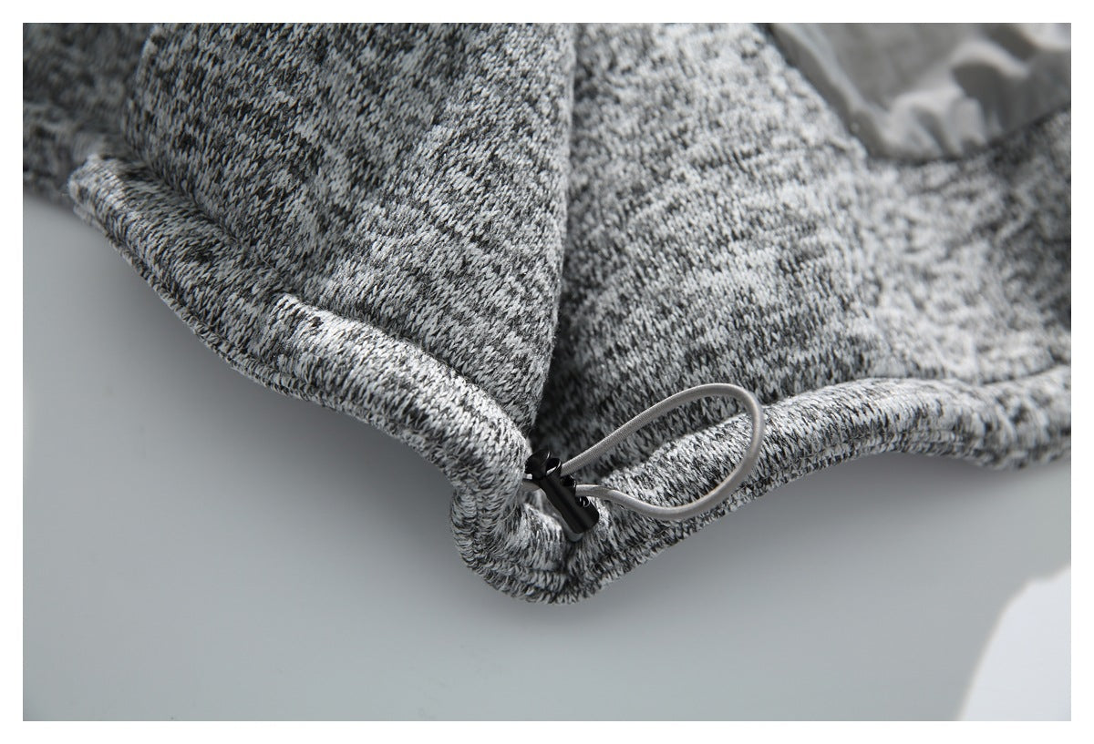 Close-up of a gray marled knit jacket hem with an adjustable drawcord and toggle.