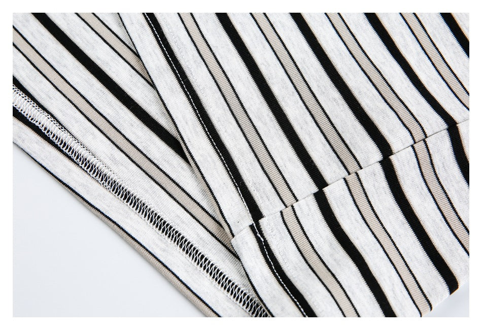 Close-up of the striped shirt hem and overlock stitching along the seam.