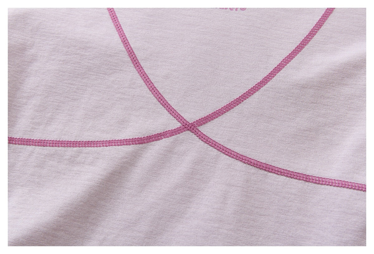 Close-up of intersecting pink seam lines on pale lavender fabric.