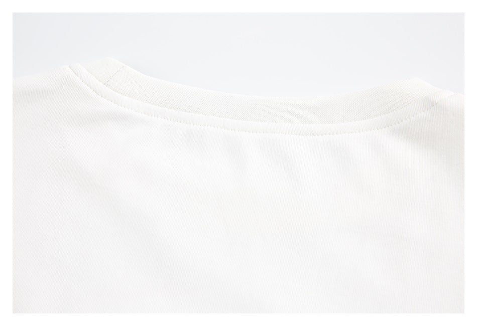 Close-up of the back neckline and collar stitching on a white T-shirt.