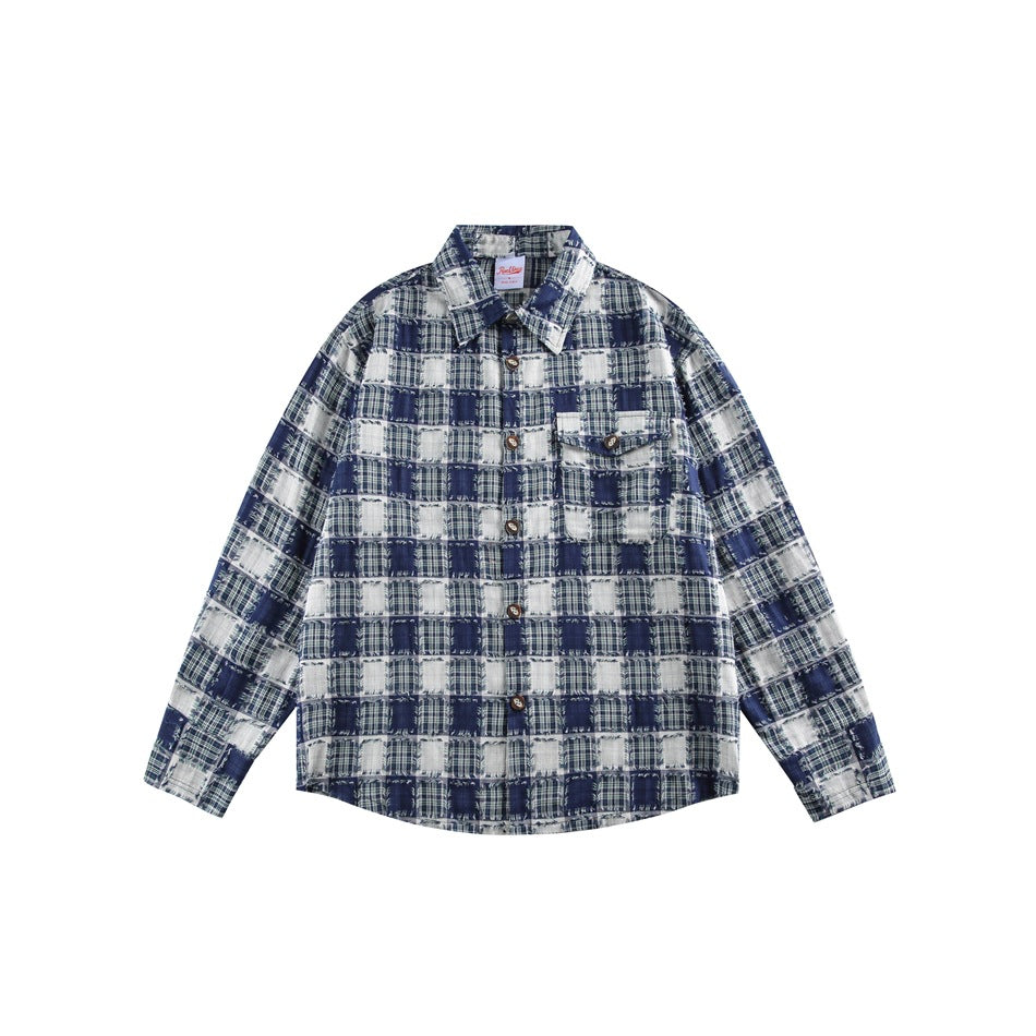 Front view of a navy and white patchwork plaid button-up shirt with a collar and two chest pockets.