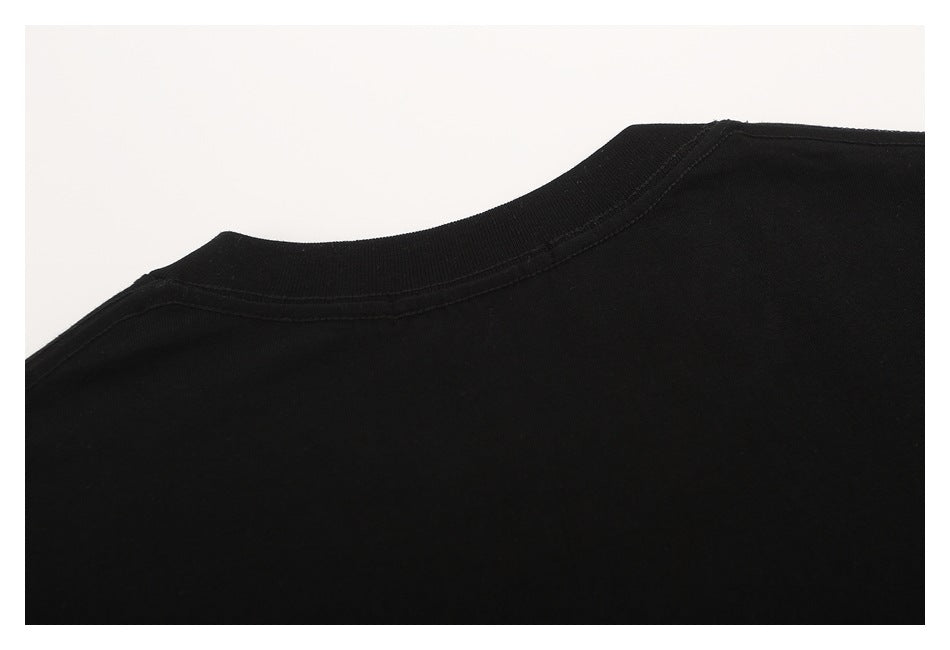 Close-up of the plain black T-shirt’s back neckline and shoulder seams.