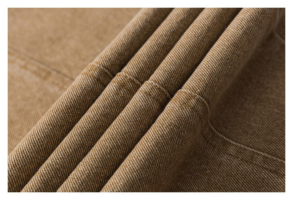 Extreme close-up of brown twill fabric arranged in parallel folds.