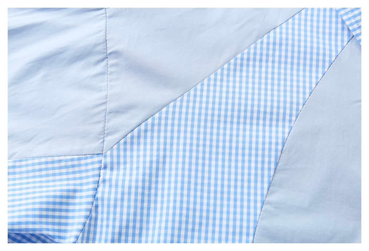 Close-up of pale blue shirt fabric joined to blue-and-white gingham panels.