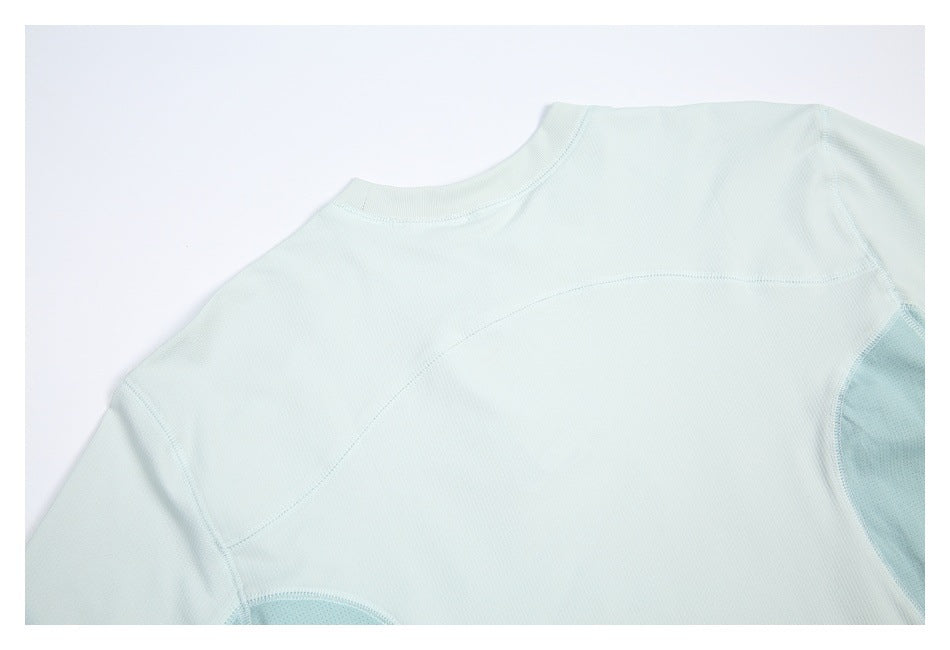 Close-up of the pale mint shirt's back neckline, shoulder seams, and perforated side panels.