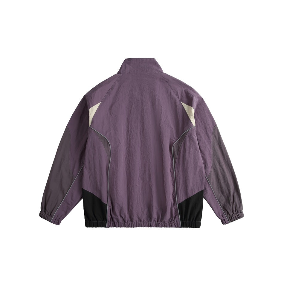 Back view of a plum color-block zip jacket with cream accents, black lower panels, and an elasticated hem and cuffs.