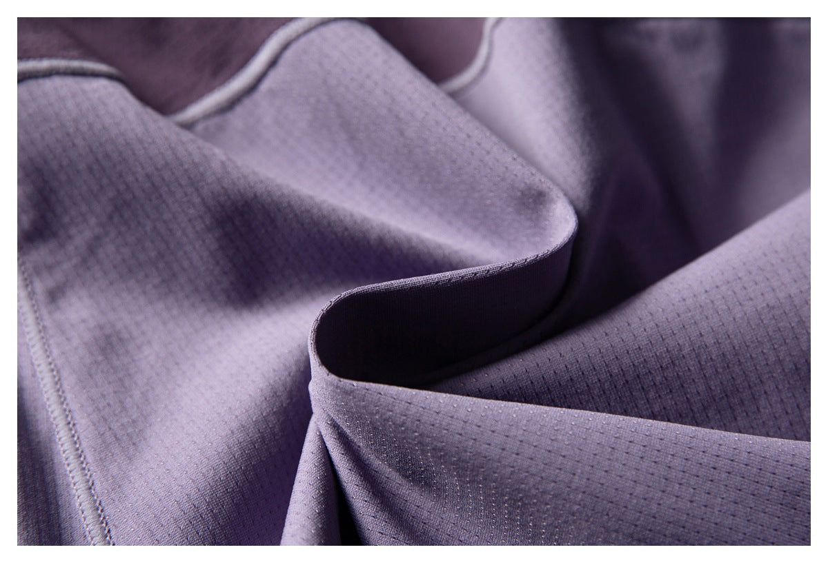 Close-up of folded purple perforated fabric showing its texture and stitched edge.