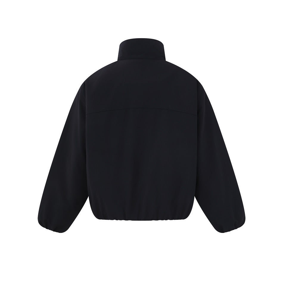 Back view of a black jacket with a high collar, curved upper-back seam, long sleeves and elasticized hem.